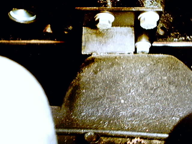 close-up of a greasy metal part with bolts
