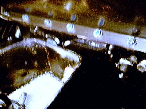 1979 Ford Bronco - This image shows a close-up view of a vehicle's undercarriage, focusing on mechanical components and fasteners.