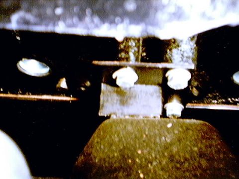 1979 Ford Bronco - Close-up of a vehicle's undercarriage, showing mechanical components and a website logo.
