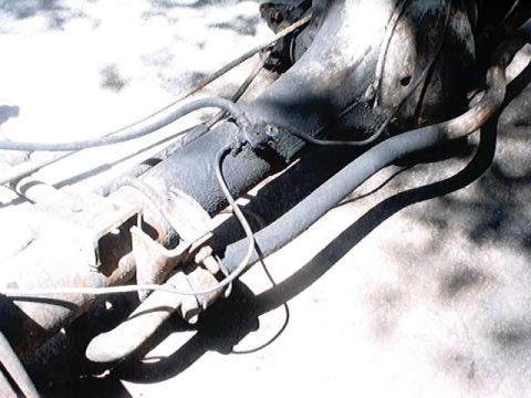 1979 Ford Bronco - Undercarriage view shows the rear axle assembly and brake lines of a vehicle.