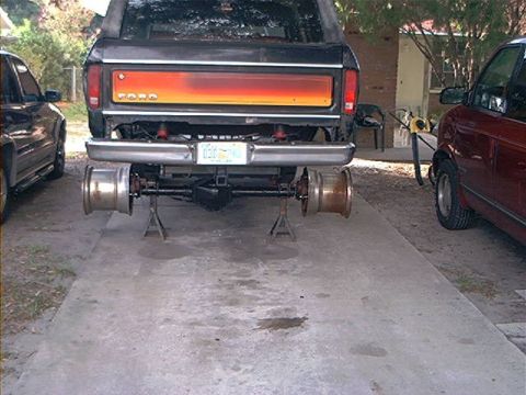 1979 Ford Bronco - Rear axle of a 1978 Ford Bronco is on jack stands, with other vehicles nearby.