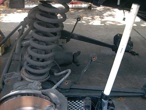 1979 Ford Bronco - Close-up view of a vehicle's front suspension system, showing various mechanical components.
