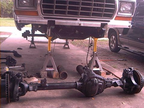1979 Ford Bronco - Front axle assembly removed from a 1979 Ford Bronco, which is supported by jack stands.