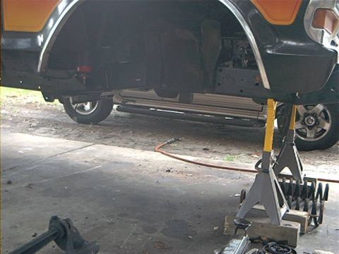 1979 Ford Bronco - Undercarriage view of a 1979 Ford Bronco, showing the rear wheel well and suspension components.