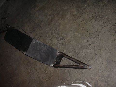 1991 Ford Bronco - A custom front bumper project, made of metal and tubing, lies on a concrete floor.