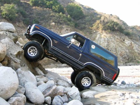 1985 Ford Bronco - This 1985 Ford Bronco navigates a challenging rocky terrain, demonstrating its off-road capabilities.