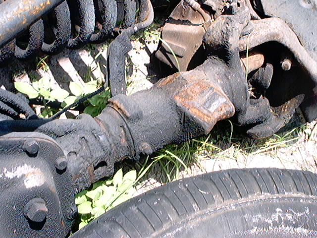 Rusty suspension parts and a tire on the ground