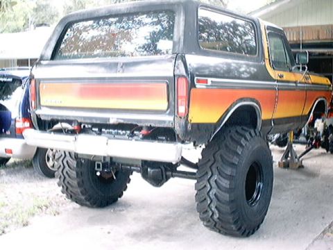 1979 Ford Bronco - Lifted 1978 Ford Bronco on jack stands, showing its rear end and large off-road tires.