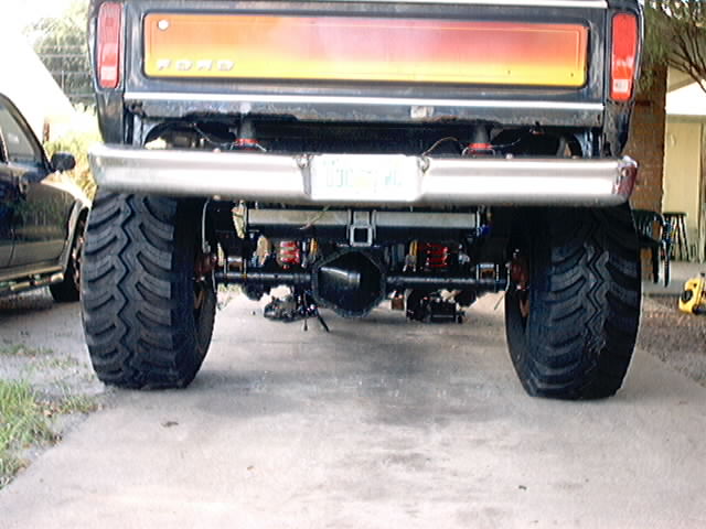 Rear view of a lifted 1978 Ford Bronco with large tires and a custom bumper