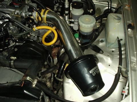2000 Ford Taurus - Aftermarket air intake system installed in a vehicle's engine bay.