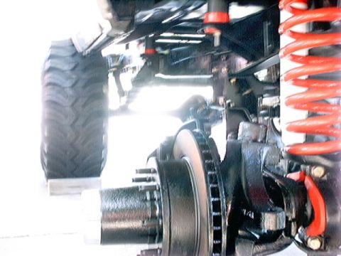 1979 Ford Bronco - Undercarriage view of a vehicle's suspension system, highlighting the tire and braking components.