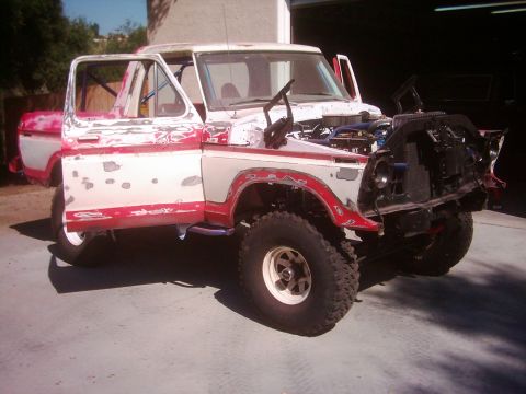 1978 Ford Bronco - This 1978 Ford Bronco is undergoing repairs, with its front end taken apart and doors open.