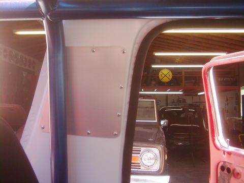 1978 Ford Bronco - View from inside a vehicle's cabin, looking out towards another vehicle parked in a garage setting.