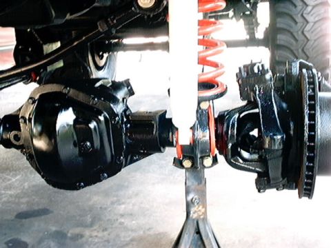 1979 Ford Bronco - Vehicle suspension and differential components are shown in detail, with a shock absorber and coil spring visible.