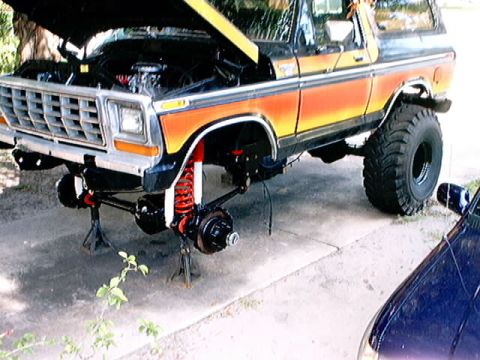 1979 Ford Bronco - This Ford Bronco is undergoing maintenance with its front end disassembled and hood open.