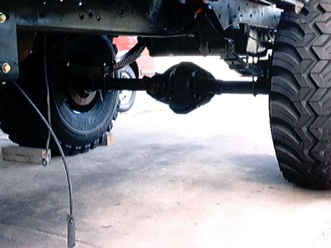 1979 Ford Bronco - Close-up of the rear axle and suspension components of a heavy-duty vehicle.