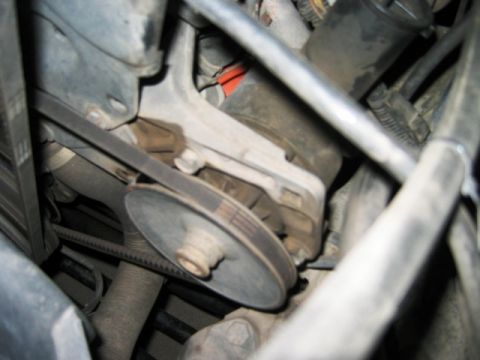 1985 Ford Bronco - Engine compartment detail showing a drive belt and pulley assembly.