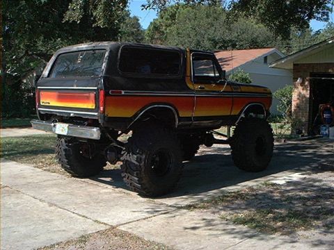 1979 Ford Bronco - This lifted Ford Bronco features a distinctive stripe paint job and oversized tires.