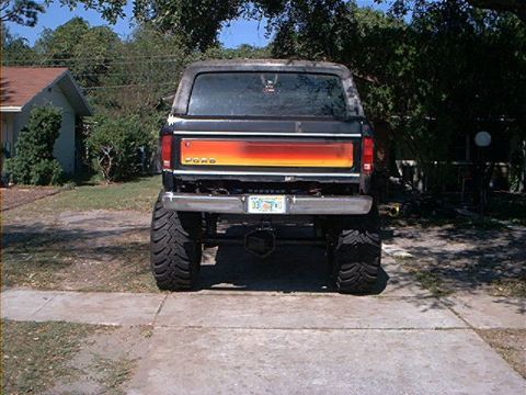 1979 Ford Bronco - This lifted Ford Bronco has a distinctive orange and yellow stripe across its tailgate.