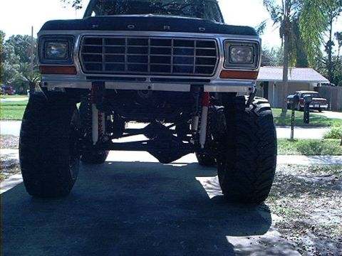 1979 Ford Bronco - Front view of a lifted 1979 Ford Bronco with oversized tires and a prominent silver grille.