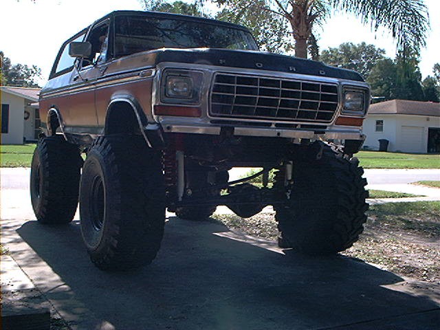 Lifted Ford Bronco with large tires, front view. Grille indicates 1978 model year