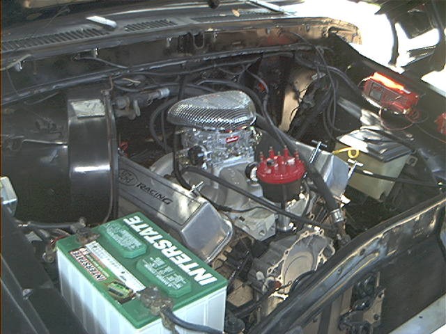 Engine bay with V8 engine, chrome air cleaner, and Interstate battery