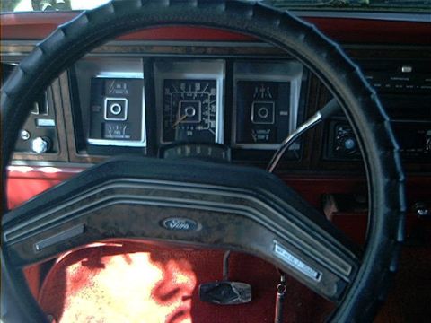 1979 Ford Bronco - Close-up of the dashboard and steering wheel of a vintage Ford vehicle, highlighting the instrument cluster.