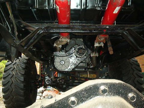 1979 Ford Bronco - Close-up view of the undercarriage, the drivetrain and suspension of a modified vehicle.