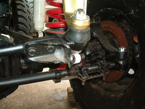 1979 Ford Bronco - Detailed view of a vehicle's front suspension and steering linkage.