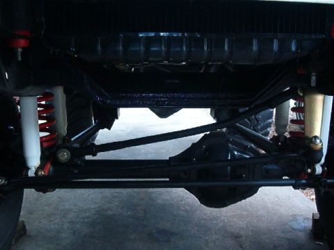 1979 Ford Bronco - Undercarriage view of a 4x4 vehicle, focusing on suspension and drivetrain parts.