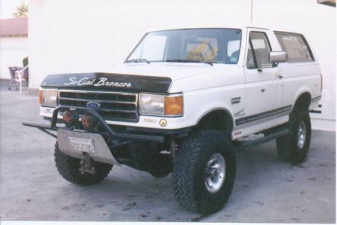 1990 Ford Bronco - This 1990 Ford Bronco features a lifted suspension, custom front bumper, and a prominent 'So Cal Broncos' decal on the hood.
