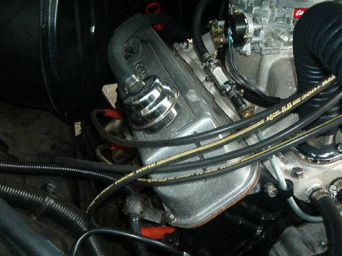 1979 Ford Bronco - A close-up view of engine components, showing spark plug wires and a carburetor.