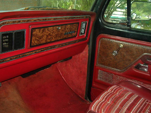1979 Ford Bronco XLT interior with woodgrain trim on dashboard and door panel