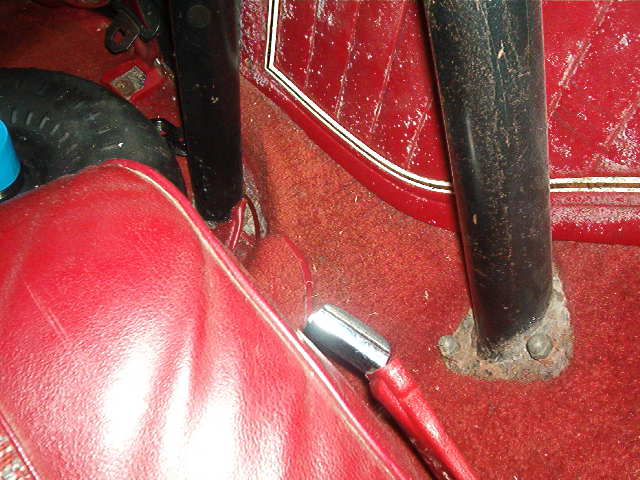 Red interior with floor shifter and roll bar support