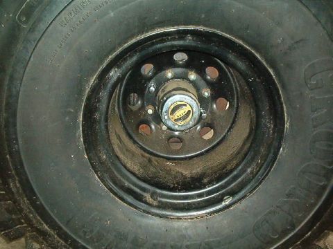 1979 Ford Bronco - Close-up of a wheel hub and tire, showing a part of a vehicle.