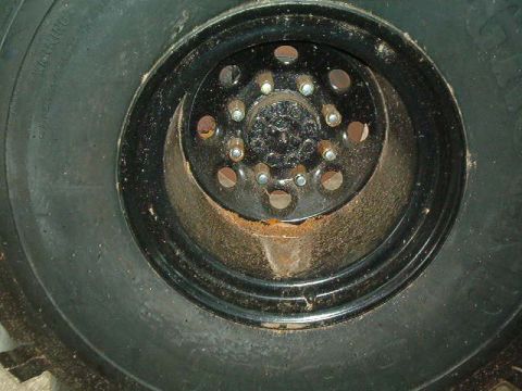 1979 Ford Bronco - A close-up view of a vehicle's wheel and tire, showing the lug nuts and rim details.