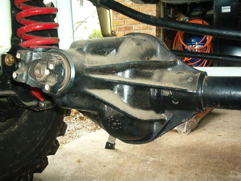1979 Ford Bronco - Close-up view of a vehicle's rear axle assembly, showing the differential housing and part of the suspension.
