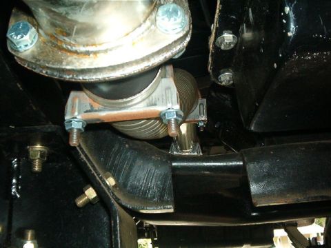 1979 Ford Bronco - Close-up view of an exhaust pipe flex joint, showing bolts and clamps.