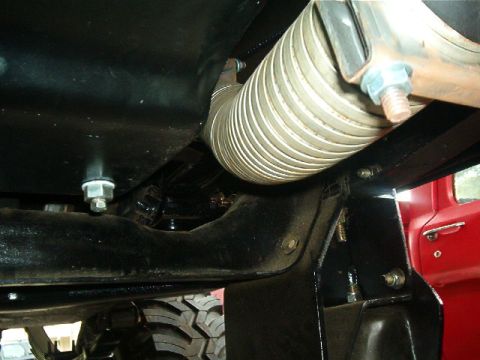 1979 Ford Bronco - Underside view shows exhaust pipe and chassis components, with tire tread visible.