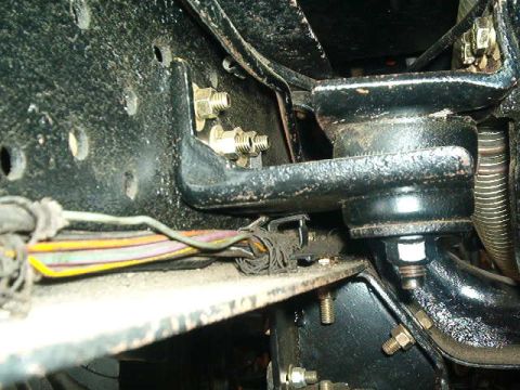 1979 Ford Bronco - Underside view of vehicle chassis components, including bolts and wiring.