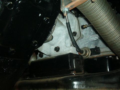 1979 Ford Bronco - Close-up view of an engine component, a black box and a sensor, with the Supermotors.net logo at the bottom.