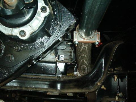 1979 Ford Bronco - Underside view of engine and exhaust system components, showing a flexible exhaust pipe section.