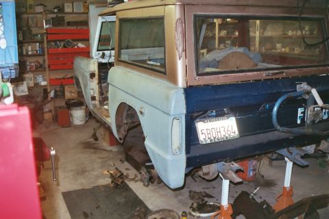 1966 Ford Bronco - 1966 Ford Bronco in garage, being worked on. It's on jack stands with the rear end exposed.
