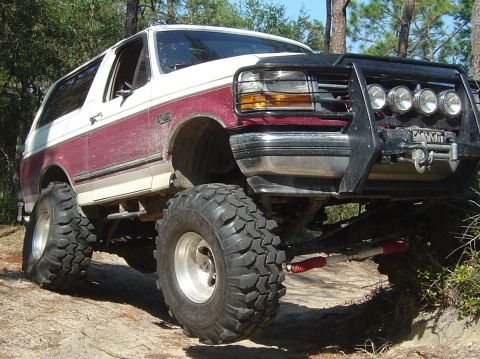 1993 Ford Bronco - This modified 1993 Ford Bronco features oversized tires and a heavy-duty bull bar, ready for off-road adventures.