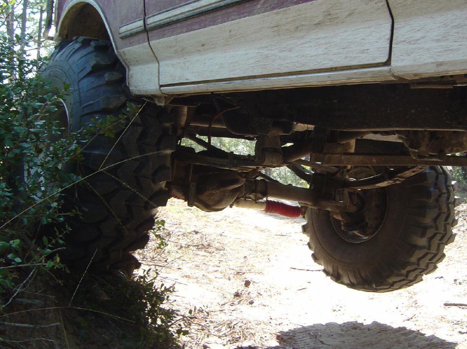 1993 Ford Bronco side view showing lifted suspension and large tires off-road