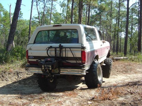 1993 Ford Bronco - This lifted Ford Bronco is equipped with off-road tires and a winch, ready for rough terrain.
