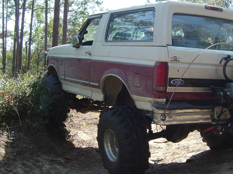 Rear view of a lifted 1993 Ford Bronco with large tires, off-roading