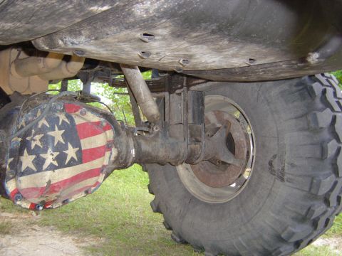 1993 Ford Bronco - The rear axle of a modified off-road vehicle features a differential cover painted with the American flag design.
