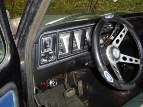 1979 Ford Bronco - Interior view of a 1979 Ford Bronco's dashboard and steering wheel, with visible gauges and Ford branding.