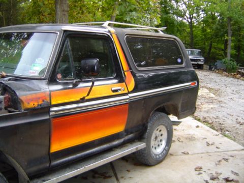 1979 Ford Bronco - This 1978 Ford Bronco has custom paint and is parked outside. Another vehicle is in the background.